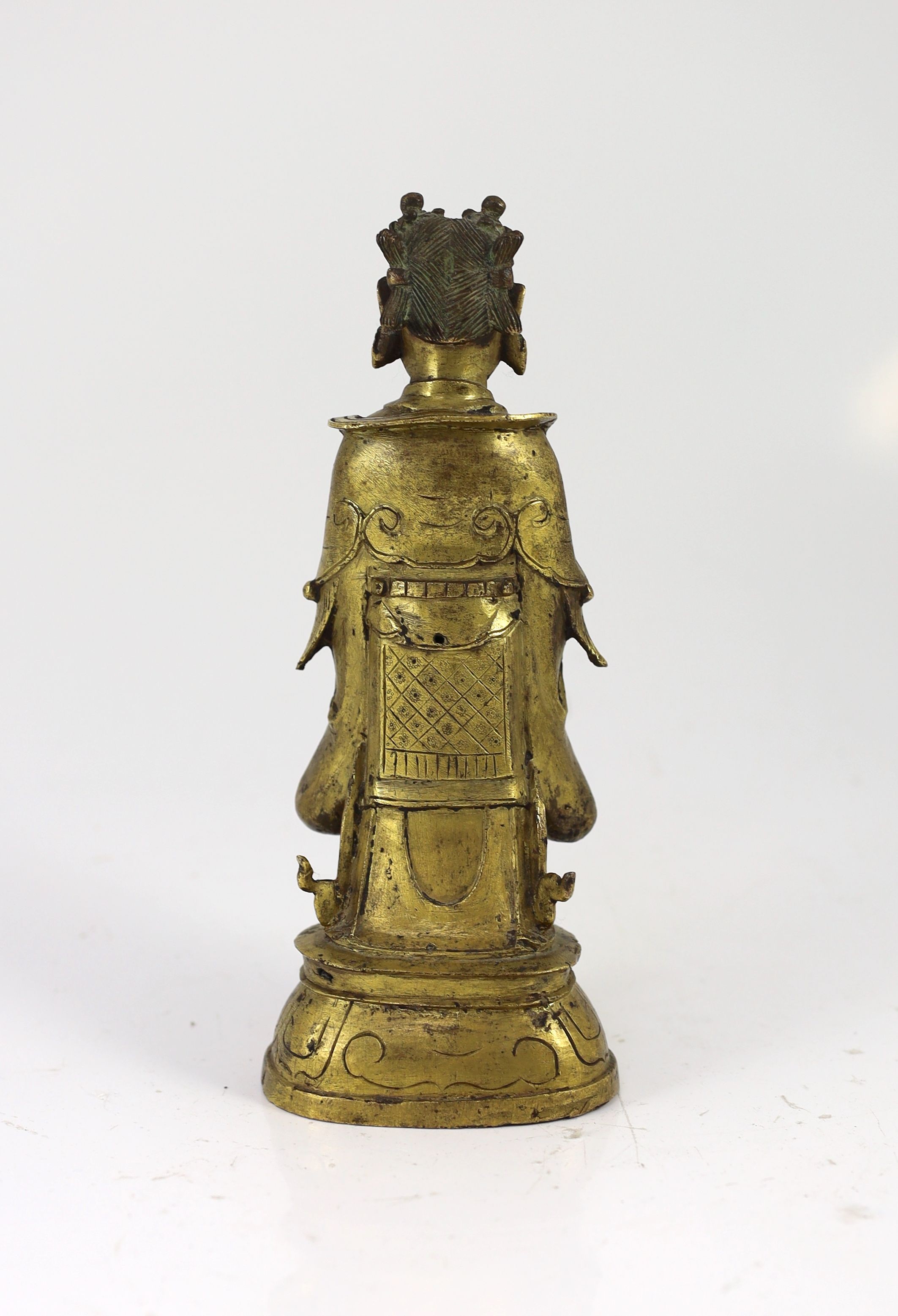 A Chinese Ming gilt bronze figure of an immortal, 16th/17th century, 24.5cm high